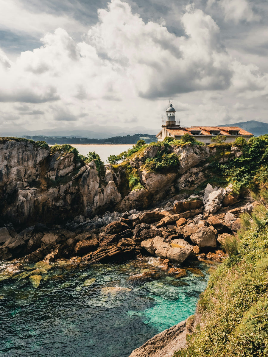 Lighthouse on a cliff above the Bay of Biscay near Santander, Cantabria — total solar eclipse, 12 August 2026