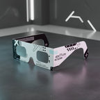 Professional still life photo of Cipher design solar eclipse glasses on a polished concrete surface, perfect for safe viewing on August 12, 2026.