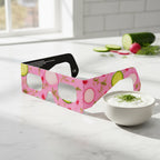 Professional still life photo of Coldsoup design eclipse glasses on a marble countertop, perfect for safe viewing. ISO 12312-2 certified.