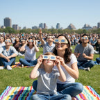 A mother helping her child with Doodle eclipse glasses at a community event, both gazing up in wonder, ISO 12312-2 compliant.