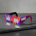 Showcasing Goo design solar eclipse glasses at an angle on a textured slate stone. ISO 12312-2 certified for safe viewing.