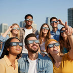 Friends at a rooftop gathering wearing helmet-design glasses, expressing excitement and joy. ISO 12312-2 certified.