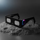 Professional product photograph of helmet-design eclipse glasses on lunar-like rock, ISO 12312-2 certified.