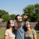 Three friends in a sunny backyard, safely viewing the sky with Nebula design glasses, ISO 12312-2 compliant.